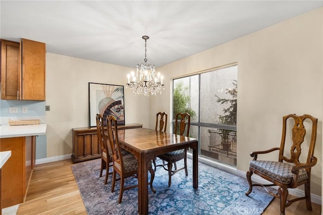 dining room featuring an inviting chandelier and light wood-type flooring