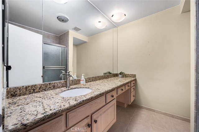 bathroom featuring tile patterned flooring, vanity, and a shower with door