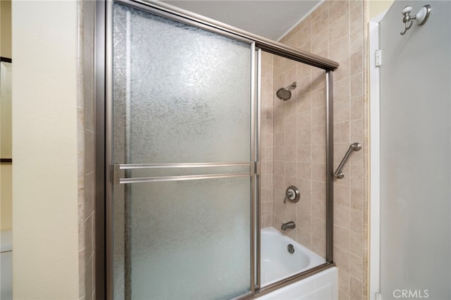 bathroom featuring shower / bath combination with glass door