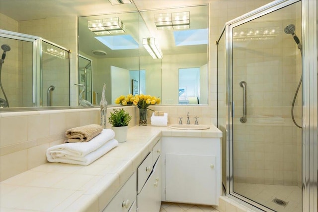 bathroom featuring vanity, backsplash, and walk in shower