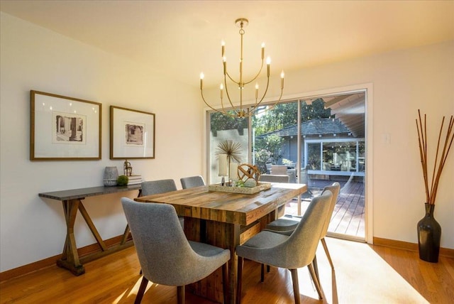 dining room featuring an inviting chandelier and light wood-type flooring