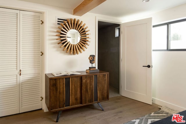 interior space with hardwood / wood-style floors and beam ceiling