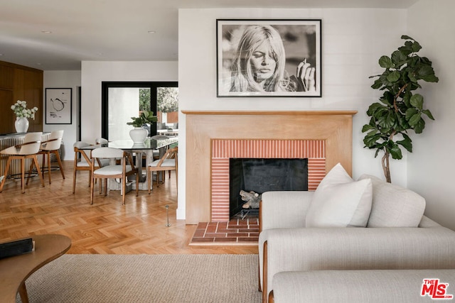 living room featuring a fireplace and light parquet flooring