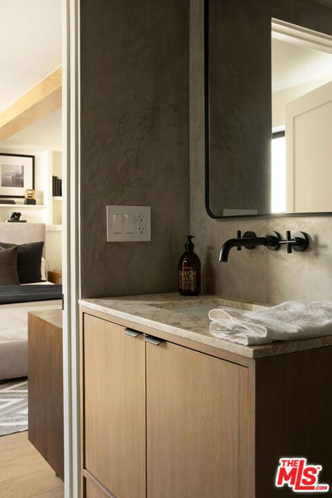 bathroom with wood-type flooring and sink