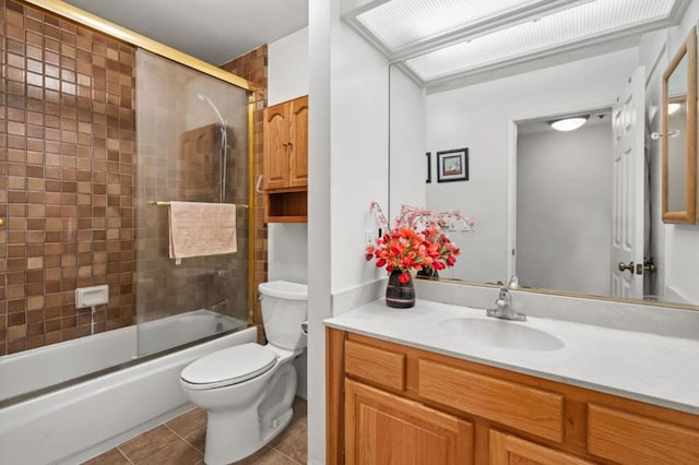 full bathroom featuring vanity, tile patterned floors, enclosed tub / shower combo, and toilet