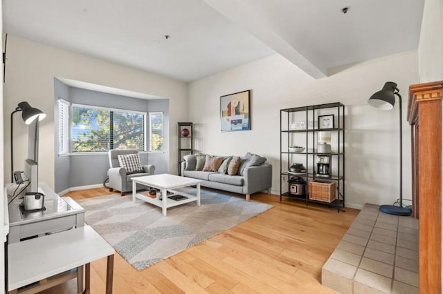 living room featuring wood-type flooring and beam ceiling