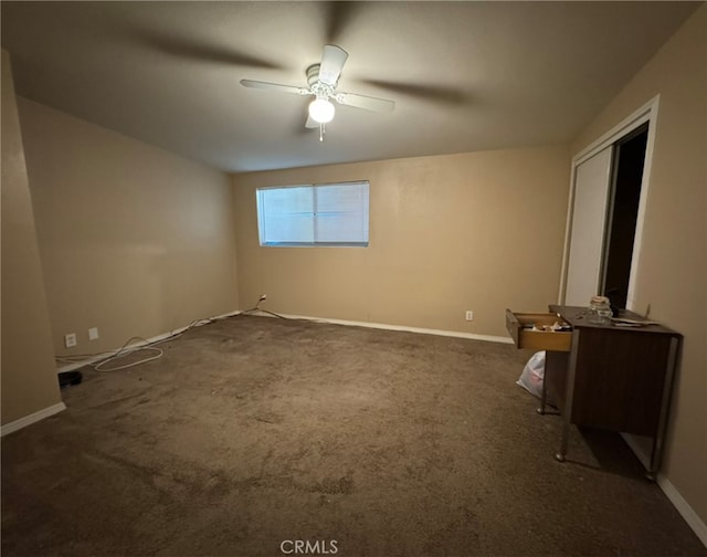 unfurnished room featuring dark carpet and ceiling fan