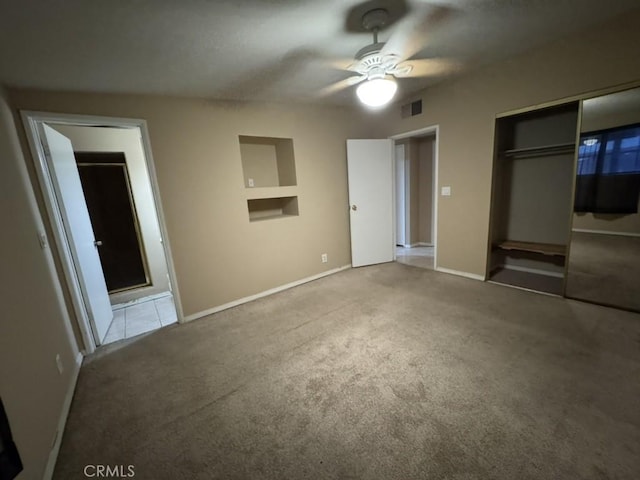 unfurnished bedroom with light colored carpet and ceiling fan