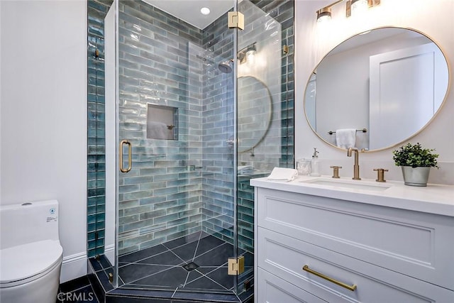 bathroom with an enclosed shower, vanity, and toilet