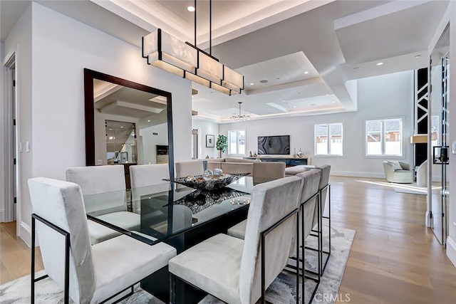 dining space with hardwood / wood-style floors and a chandelier