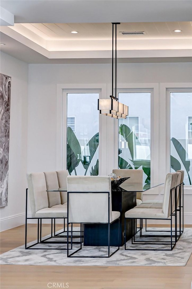 dining space with hardwood / wood-style floors