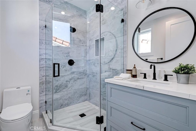 bathroom featuring vanity, toilet, and walk in shower