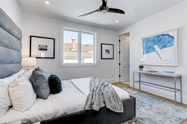 bedroom with ceiling fan and wood-type flooring