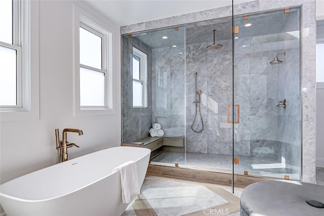 bathroom featuring separate shower and tub