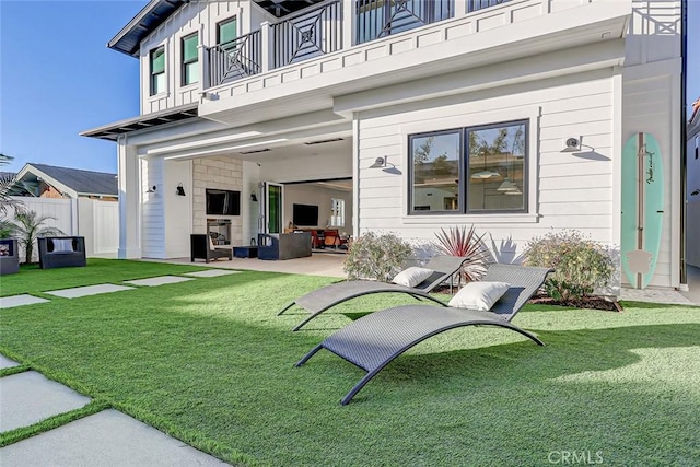 exterior space featuring a patio, a balcony, and a yard