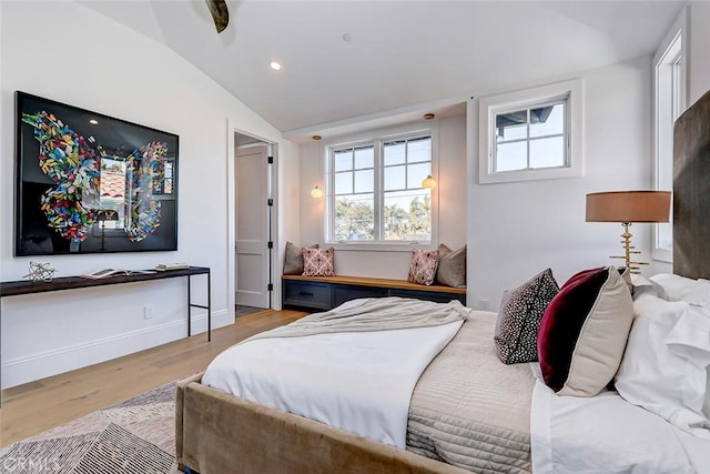 bedroom featuring lofted ceiling and light hardwood / wood-style floors