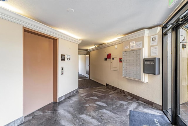 corridor featuring crown molding and mail boxes