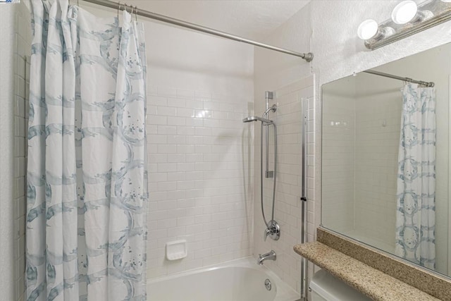 bathroom with shower / bath combo with shower curtain