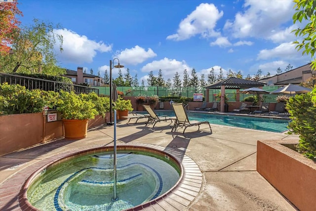 view of pool with a gazebo, a hot tub, and a patio