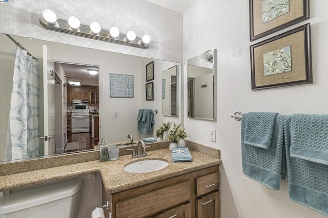 bathroom featuring vanity and toilet