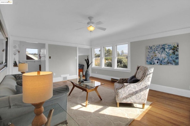 living room featuring ceiling fan and light hardwood / wood-style flooring