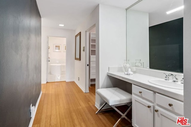 bathroom with vanity and hardwood / wood-style floors