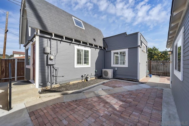 rear view of property with a patio area and ac unit