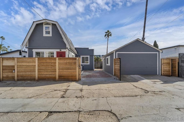 view of front of home featuring a garage and an outdoor structure