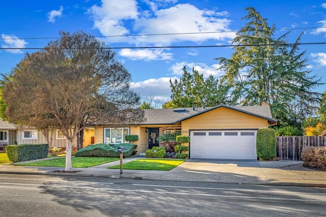 single story home with a garage and a front lawn