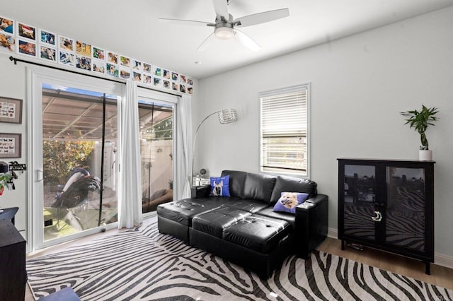 living room with hardwood / wood-style flooring and ceiling fan