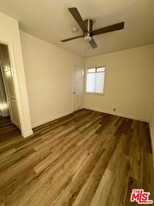 interior space featuring dark hardwood / wood-style flooring and ceiling fan