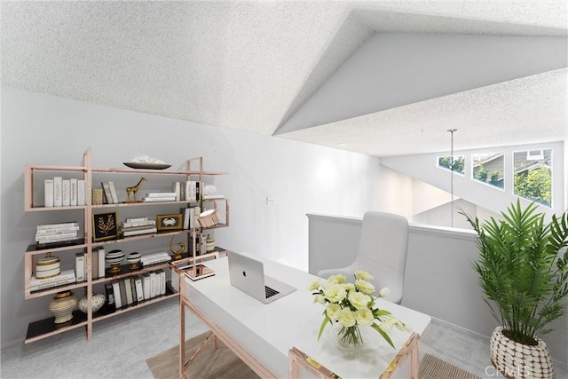 office space with lofted ceiling, light colored carpet, and a textured ceiling