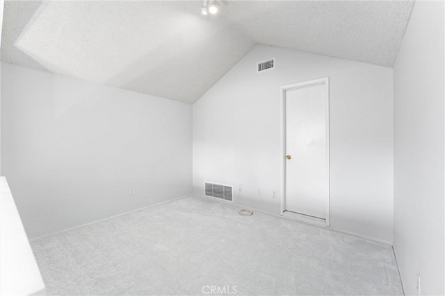 bonus room featuring vaulted ceiling and light carpet