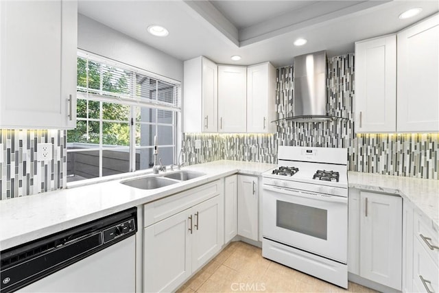 kitchen featuring white cabinetry, sink, decorative backsplash, white appliances, and wall chimney exhaust hood