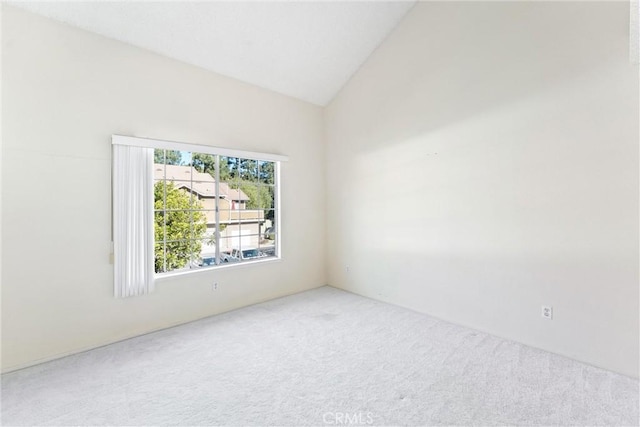 empty room featuring lofted ceiling and carpet flooring