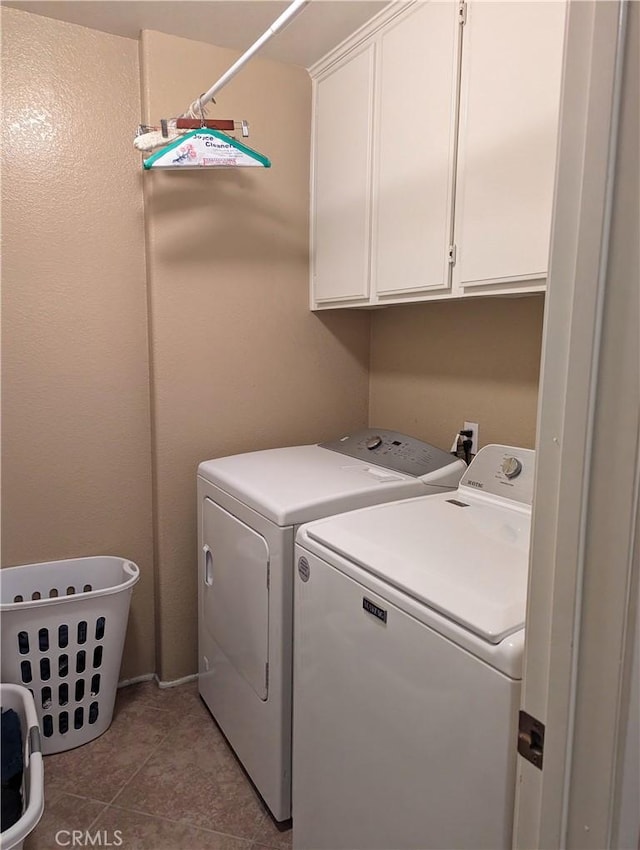 washroom with cabinets, tile patterned flooring, and washer and dryer