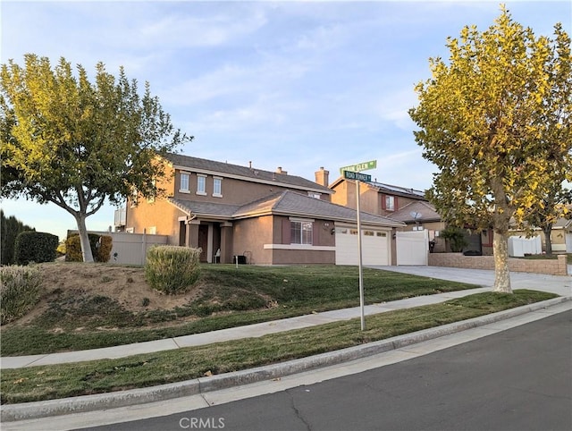 view of front of property featuring a garage and a front lawn