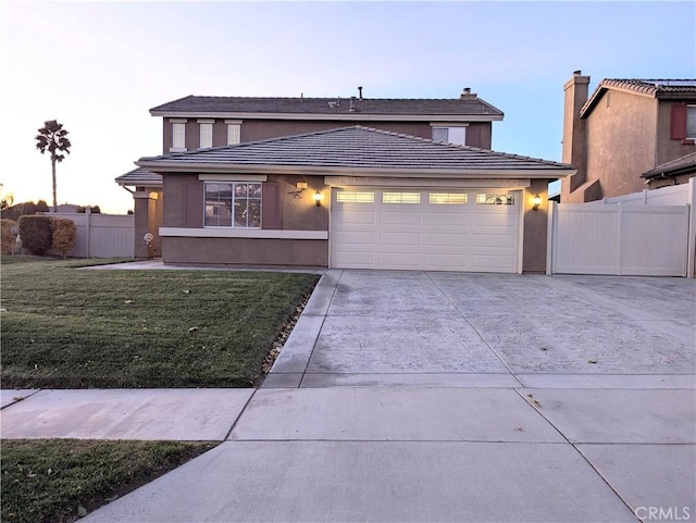 view of front of house with a garage and a lawn