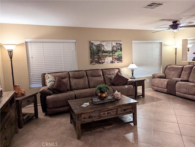 living room featuring ceiling fan and light tile patterned flooring