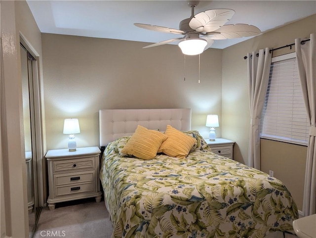 carpeted bedroom featuring a closet and ceiling fan