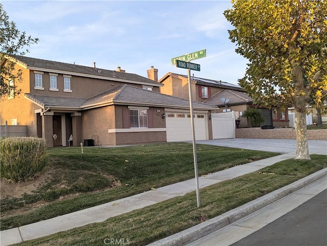 view of front of property with a garage and a front yard