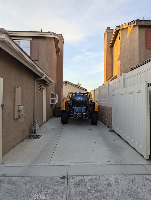 view of home's exterior featuring a wall mounted air conditioner and a patio area