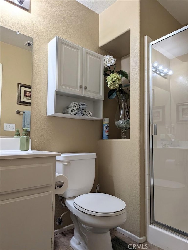 bathroom featuring vanity, toilet, and walk in shower