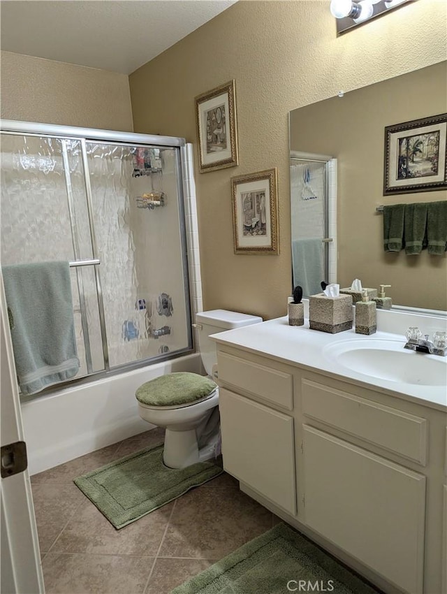 full bathroom with vanity, shower / bath combination with glass door, and toilet