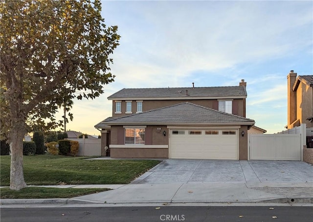 view of front of house with a garage and a yard