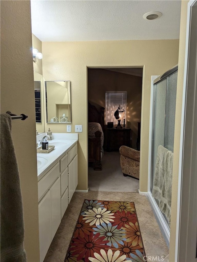 bathroom with vanity, tile patterned floors, and walk in shower