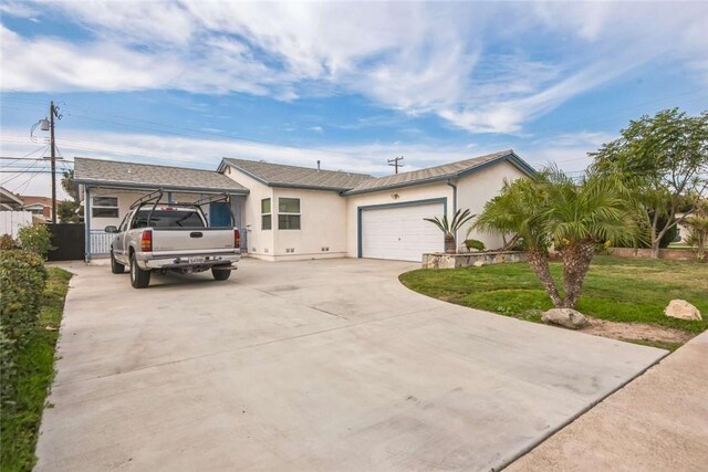 ranch-style house featuring a garage and a front lawn