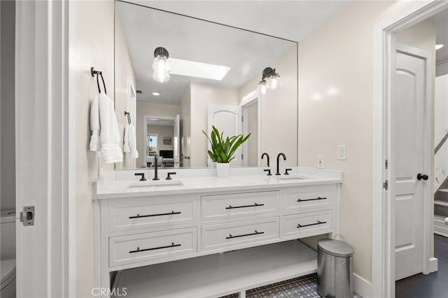 bathroom with vanity and a skylight