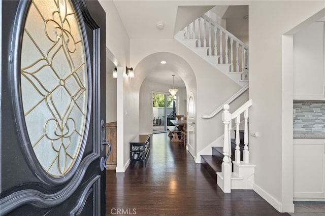 foyer entrance with dark hardwood / wood-style floors