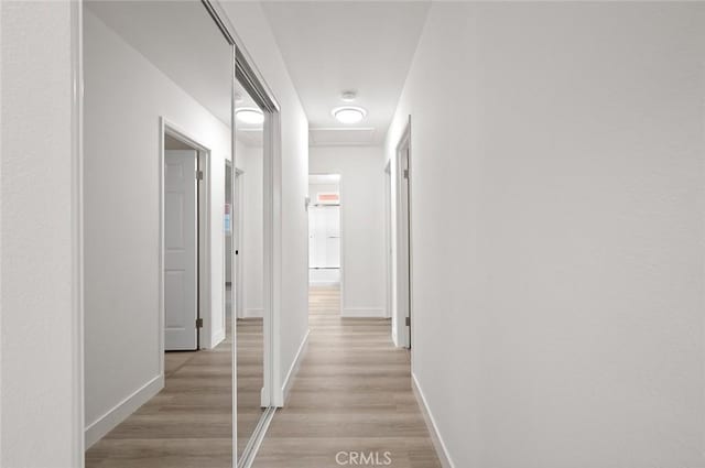 hallway with light hardwood / wood-style floors